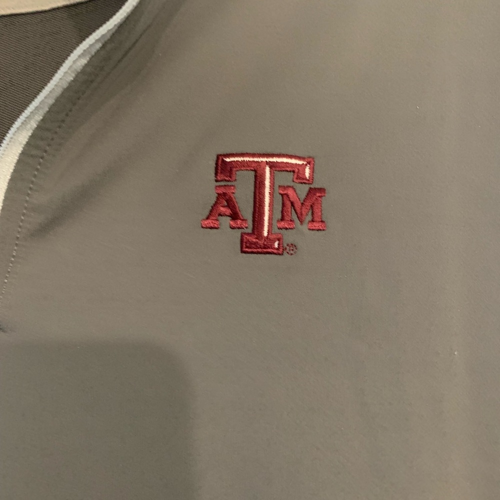 Peter Millar size L medium gray with A&M embroidered on front. Has quarter zipp.